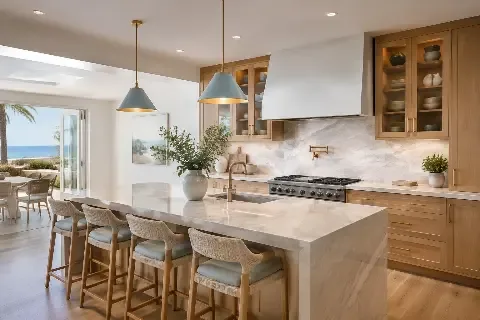 Kitchen with a white stone island, glass pendants and an ocean view window